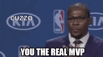 a man in a suit and tie is standing in front of a kia logo and a basketball player .