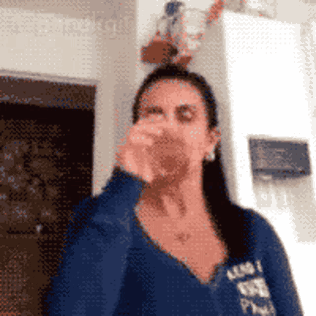 a woman wearing a blue shirt that says abercrombie and fitch on it