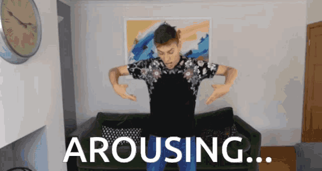 a man is standing in front of a green couch with the words arousing written on the bottom