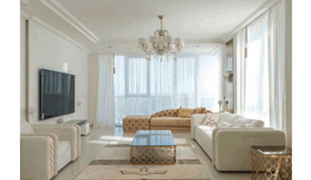 a living room with white furniture and a large flat screen tv