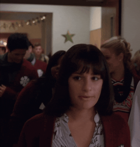 a woman wearing a red cardigan and a shirt that says ' lsu ' on it
