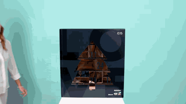a woman standing next to a box that says eis