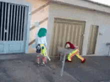 a child in a clown costume is standing in front of a building