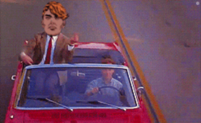 a man in a suit is driving a red convertible