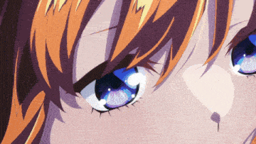 a close up of a girl 's blue eyes with orange hair
