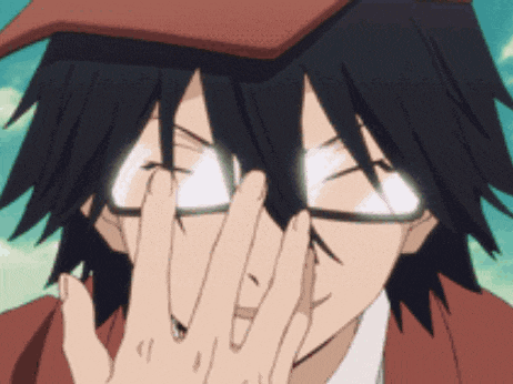 a man with glasses and a hat is covering his eyes with his hand