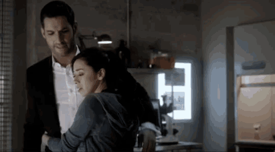 a man and a woman are standing next to each other in a room .