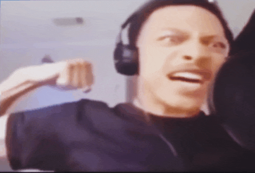 a blurry picture of a man wearing headphones making a funny face