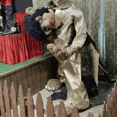 a stuffed animal in a lion costume with a knife