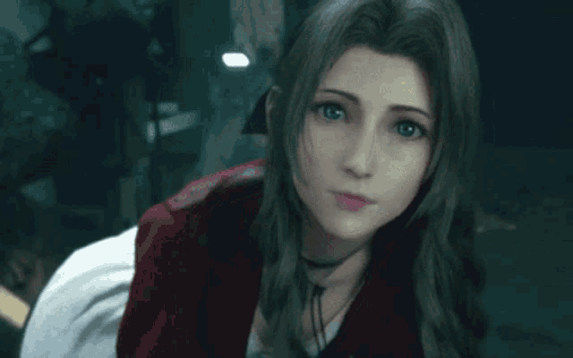 a close up of a woman 's face with a red jacket on