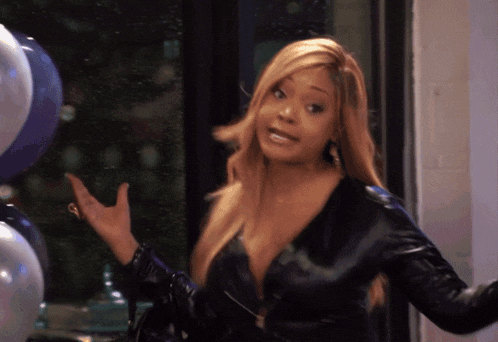 a woman in a black leather jacket is pointing at something