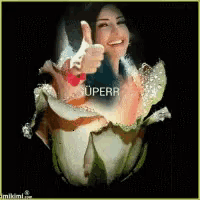 a woman giving a thumbs up in front of a flower with the word superr written on it