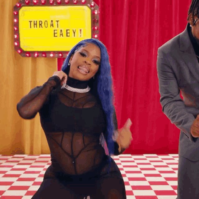a woman with blue hair is dancing in front of a yellow sign that says throat eaey