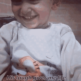 a little girl is smiling with the words his laugh gives me life written below her