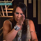 a woman with long hair is sitting in front of a sign that says ' chef celebrity '