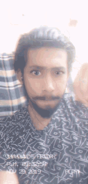 a man with a beard is wearing a shirt that says star wars