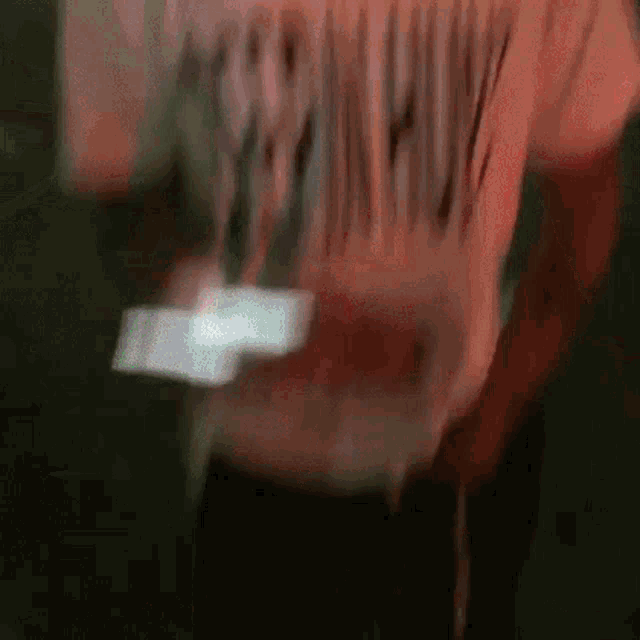 a blurry picture of a person wearing a shirt that says ' nirvana ' on the back
