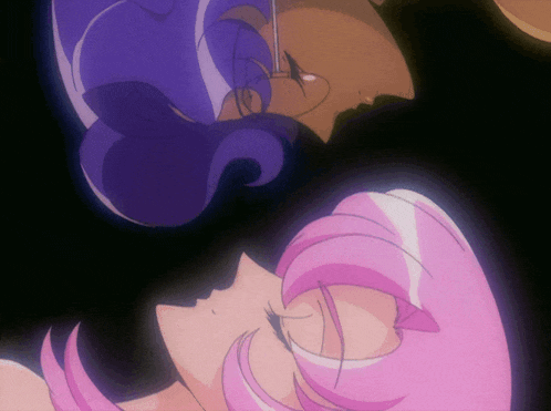a man and a woman with pink hair are kissing