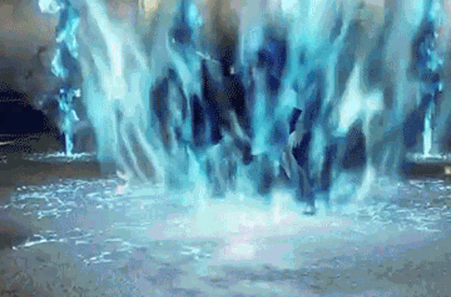 a group of people are standing in a pool of water with a blue light coming out of them .