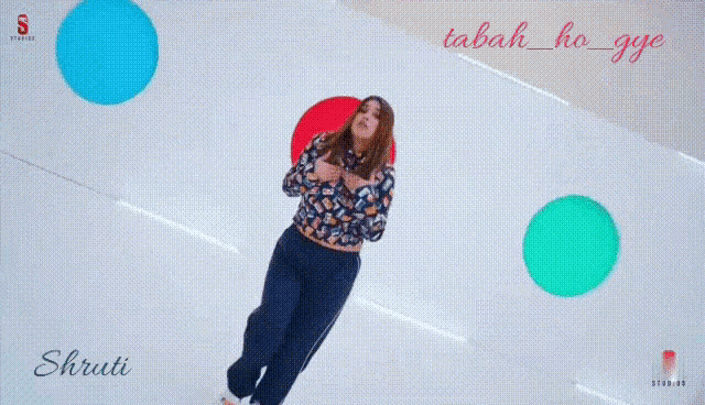 a woman is giving a thumbs up sign while wearing a crop top .