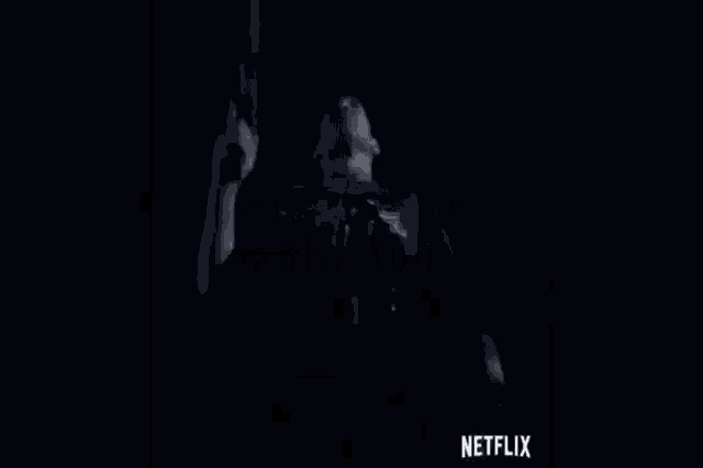 a man is holding a gun in a dark room with the words " esta guayando fala 300 " above him