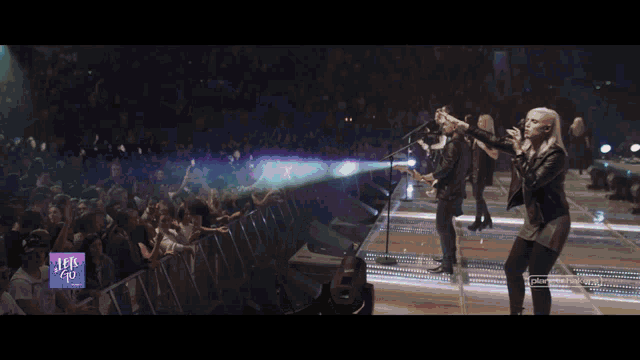 a blurred image of a band on stage with a watermark that says ' planetashakespeare ' on the bottom
