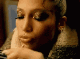 a close up of a woman 's face with lipstick on her lips