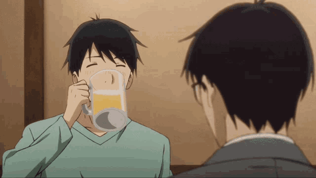 a man in a green shirt is drinking a beer