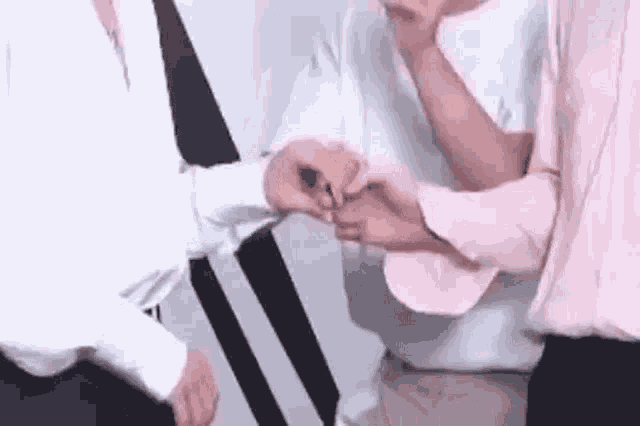 a group of people are making a heart with their hands .