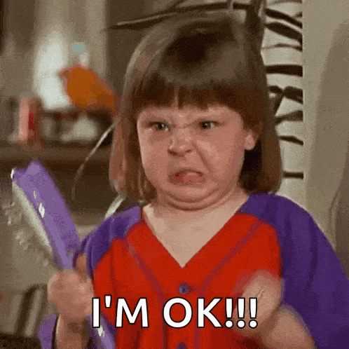 a little girl is making a funny face and saying i 'm ok !!