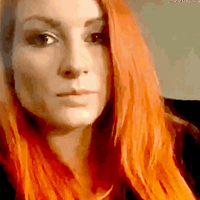 a close up of a woman 's face with the hashtag #thenextround visible