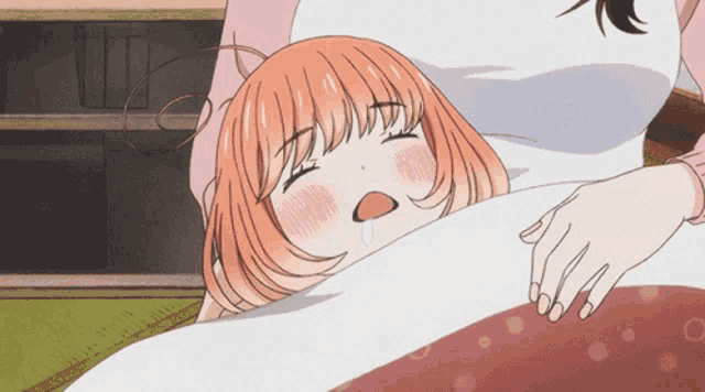 a girl with orange hair is laying on a bed with a white blanket