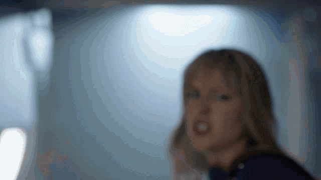 a blurry picture of a woman in a blue shirt