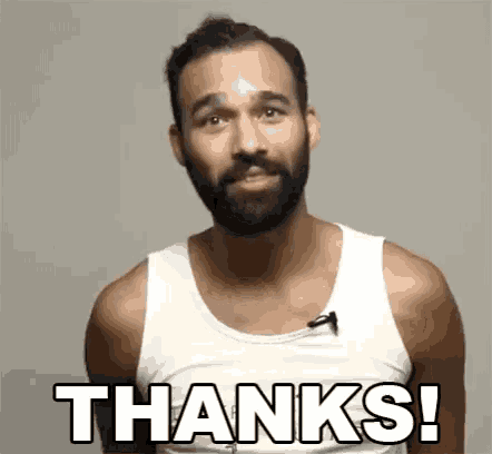 a man with a beard is wearing a white tank top and saying `` thanks '' .