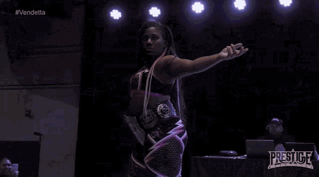 a woman in a wrestling ring with the word prestige on the bottom