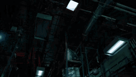 a woman in a red cape is kneeling down in a warehouse