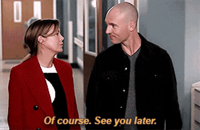 a man and a woman are standing next to each other in a hallway and the man says of course see you later