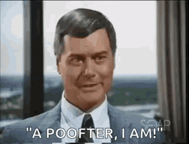 a man in a suit and tie is standing in front of a window and says `` a poofer , i am '' .