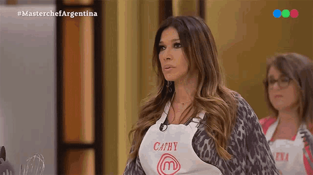 a woman wearing a white apron with cathy on it