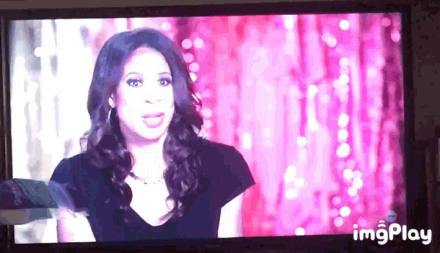 a tv screen shows a woman with a pink background and the words imgplay below it