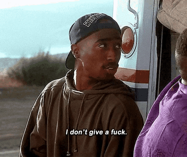 a man wearing a baseball cap and a hoodie says i don t give a fuck .