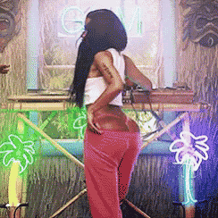 a woman in red pants is standing in front of a neon sign that says gm