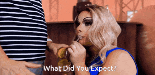 a woman in a blue dress is licking a man 's penis with the words what did you expect written below her