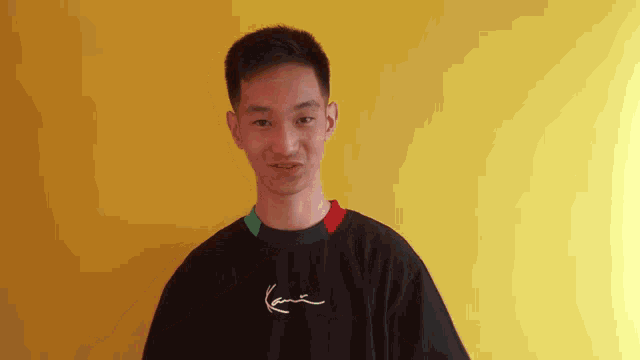 a young man wearing a black shirt with karl kani on it