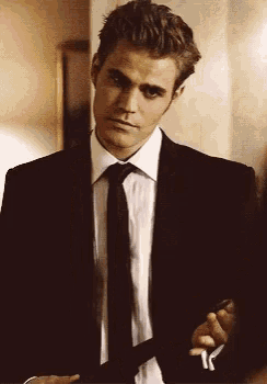 a man in a suit and tie is holding a key