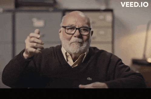 an older man wearing glasses and a sweater with a lacoste logo on it