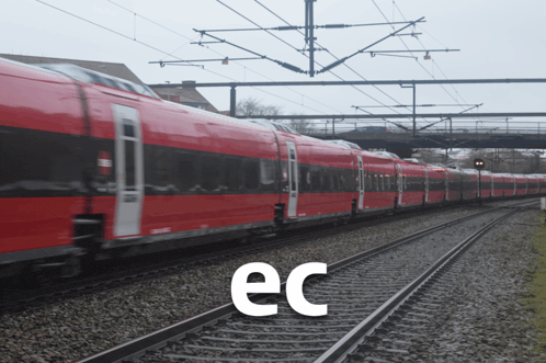 a red train is on the tracks with the letter ec below it