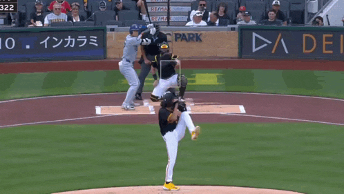 a baseball game is being played in front of a park banner