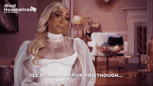 a woman says " i 'll be praying for you though " while wearing a white dress