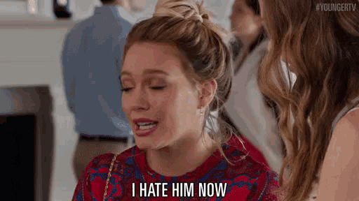 a woman is saying `` i hate him now '' while sitting next to another woman .